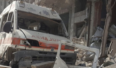 Syria, Aleppo, Al-Kallaseh district. The remains of an ambulance in the debris. 