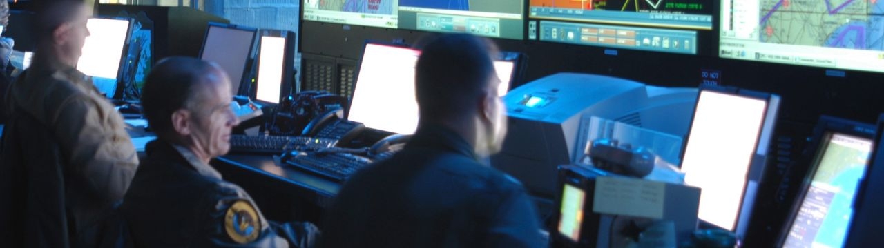 Joint Operations Center watch standers review the latest battle assessment while participating in Combined Joint Task Force Exercise (CJTFEX) 04-2 aboard the command ship USS Mount Whitney (LCC 20). 