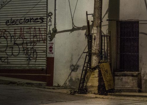 Mexico, two persons walk in th street at night