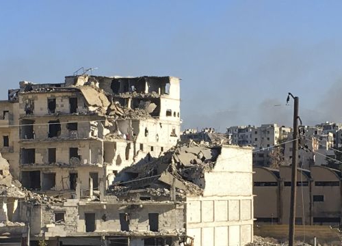 Aleppo. Buses await to enter Eastern Aleppo to evacuate civilians while sporadic fighting continues and houses are burning.