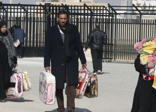 Syrian Refugees leave a blanket distribution center in Mafraq, Jordan.