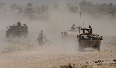 Afghanistan, Khandahar. After a road bomb destroyed a US Army vehicle, troops are patrolling the area to look for clues.