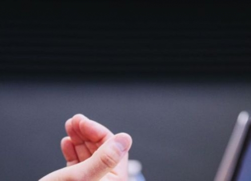 Hands before a computer screen