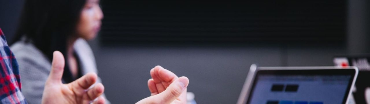 Hands before a computer screen