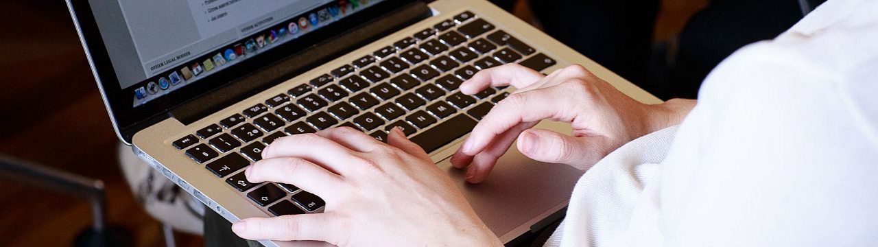 Geneva Academy student taking notes on a laptop