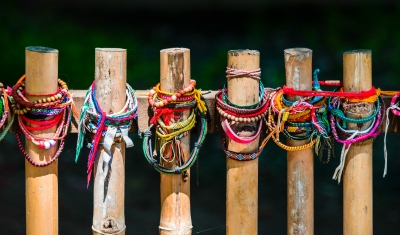 Friendship bands around a mass grave marker.  Killing Fields, outside Phnom Penh.