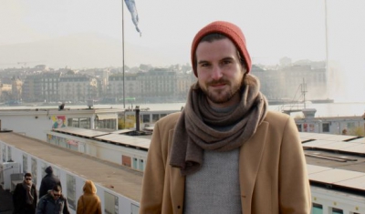 Alexis Comninos, LLM student at the Geneva Academy, in front of the Bains des Pâquis