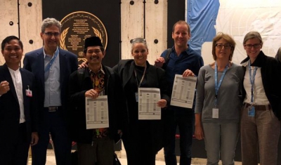 Academics and civil society holding the UN declaration after its adoption