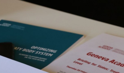 Papers related to the Geneva Human Rights Platform on a table