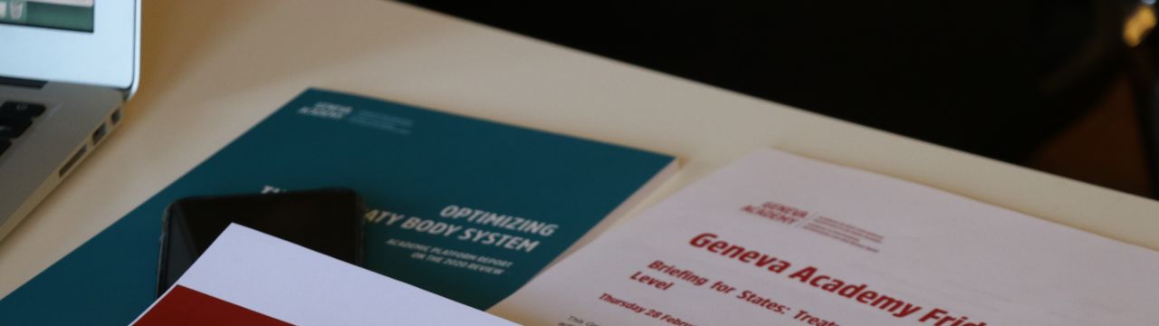 Papers related to the Geneva Human Rights Platform on a table