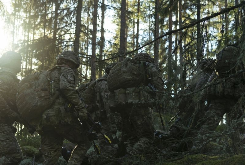 Troops from the Duke of Lancaster's Regiment working hard through the harsh Norwegian terrain as they extract a simulated casualty during FIWAF (fighting in woods and forests) training in Norway as part of Exercise Trident Juncture.