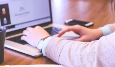 A student typing on a computer