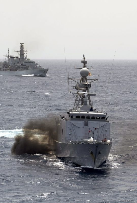 A Kenyan Navy Patrol vessel conducts navigational drills with Type 23 frigate HMS Monmouth (background) in the Indian Ocean.