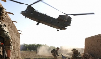 A Royal Air Force CH-47 Chinook helicopter arrives to extract troops at the end of an operation in Afghanistan
