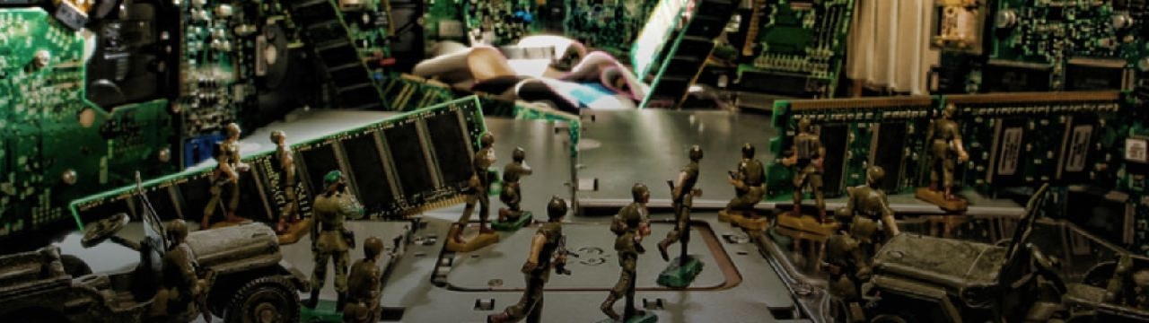 Toy soldiers siulating a fight in a context of electronic computer circuits