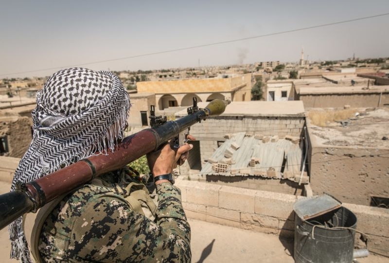 yria - Raqqa West - Frontline. A soldier from the SDF (Syrian Democratic Forces) looks at the neighborhood with his RPG.