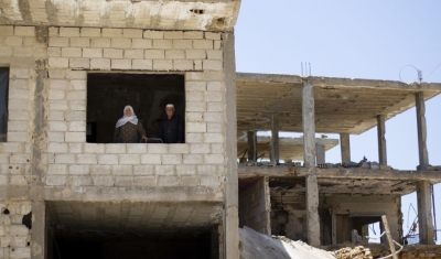 Syria,  Zabadani. A displaced couple return to their home with their daughter. His son and his family will move in once their apartment is restored. 