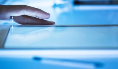 Hand on a tablet on cyber space table screen