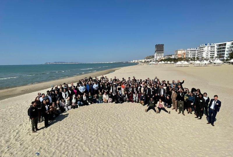 Group photo of participants on the beach