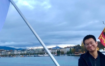 Tong Li on the Mont-Blanc Bridge with the Geneva Academy flags