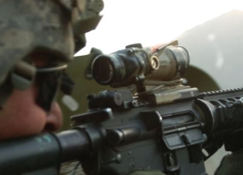 A U.S. Army Soldier with 1st Battalion, 32nd Infantry Regiment, 10th Mountain Division, fires an M-4 rifle during a gun battle with insurgent forces in Barge Matal, during Operation Mountain Fire, July 12. 