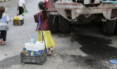 Yemen, Sana'a. Children seeking water, May 2015